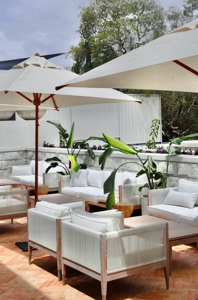 a white lounge chair and umbrella